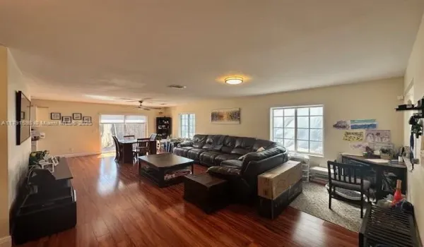 Expansive living and dining area with access to rear patio. Three large windows and sliding glass door offer plenty of light.