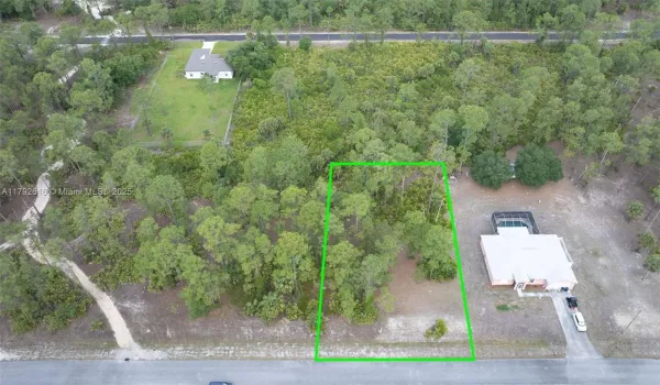 Aerial view of a buildable half-acre lot in a growing neighborhood